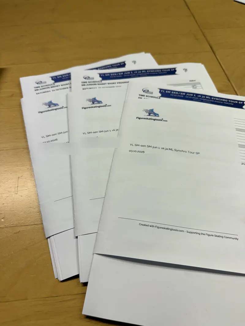 Printed judges' papers with the Figureskatingtools logo, sorted on a table